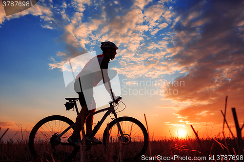 Image of mountain biker silhouette in sunrise