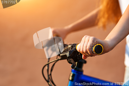 Image of teenage girl and bike in city