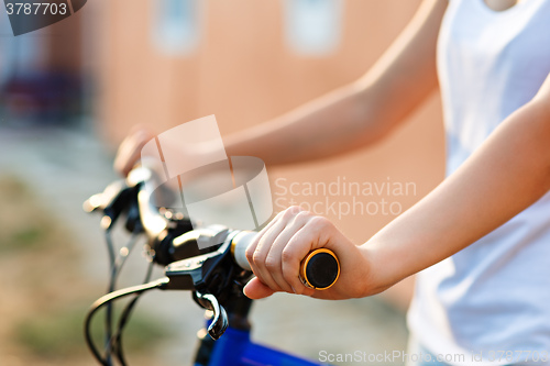 Image of teenage girl and bike in city