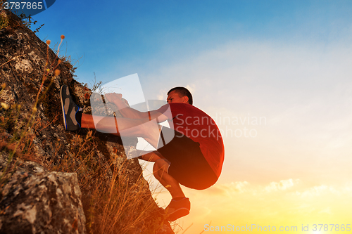 Image of Young man climbing on a wall