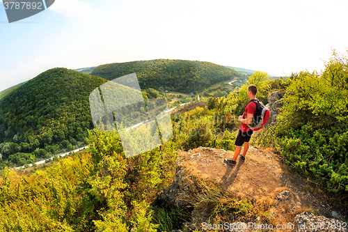 Image of Men walk along the hill with backpack