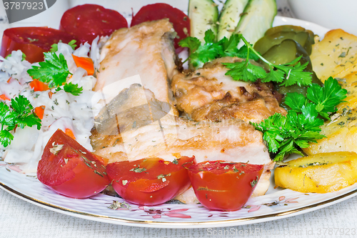 Image of Baked fish and vegetables .