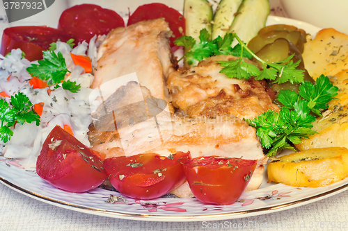 Image of Baked fish and vegetables .