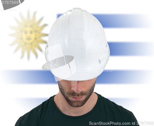 Image of Engineer with flag on background - Uruguay