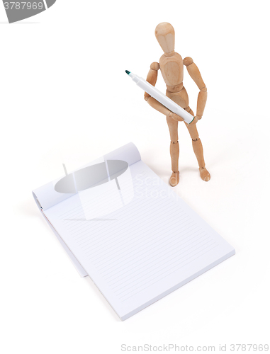 Image of Wooden mannequin writing 