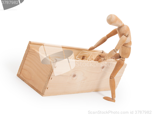 Image of Wood figure mannequin stepping in a wooden box