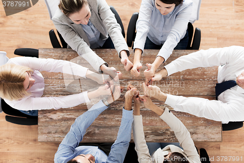 Image of business team showing thumbs up