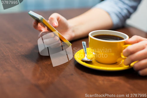 Image of close up of woman with smartphone and coffee