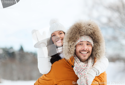 Image of happy couple having fun over winter background