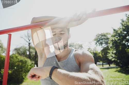 Image of man with heart-rate watch exercising outdoors