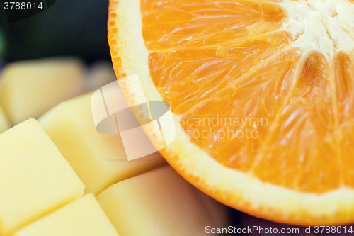 Image of close up of fresh juicy orange and mango slices