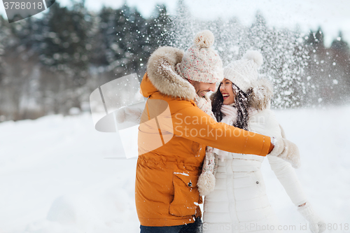 Image of happy couple hugging and laughing in winter