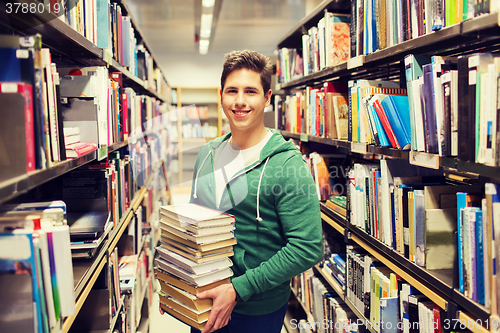 Image of happy student or man with book in library