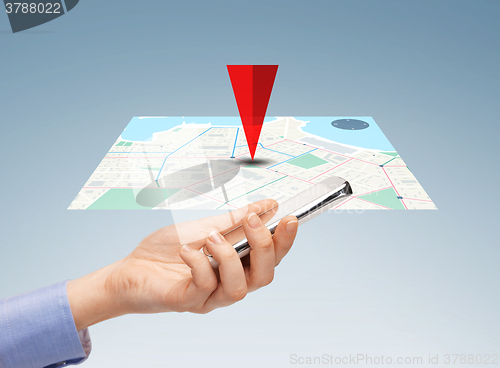 Image of close up of hand with smartphone and navigator map