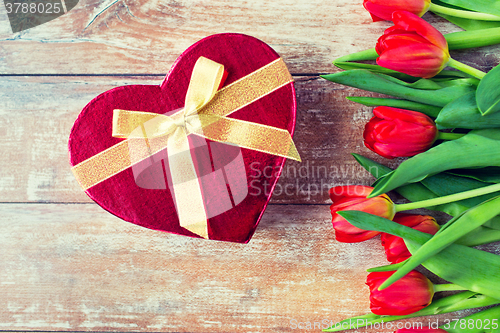 Image of close up of red tulips and chocolate box