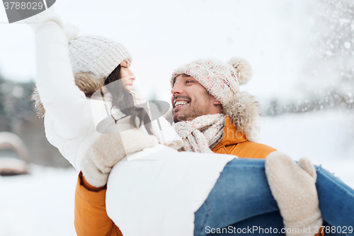 Image of happy couple outdoors in winter