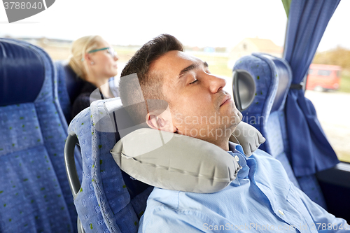 Image of man sleeping in travel bus with cervical pillow