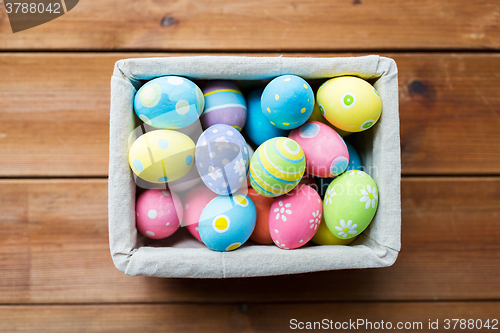 Image of close up of colored easter eggs in basket