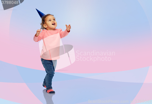 Image of happy little baby girl with birthday party hat