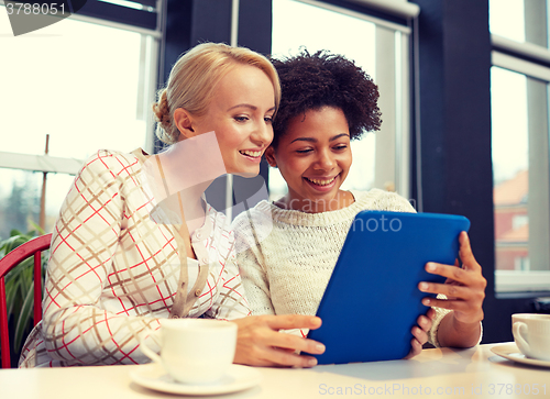Image of happy young women drinking tea or coffee at cafe