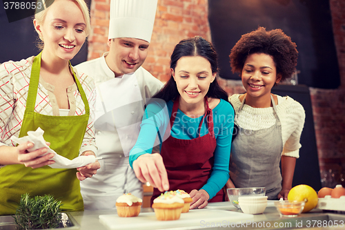 Image of happy women and chef cook baking in kitchen