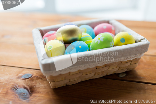 Image of close up of colored easter eggs in basket