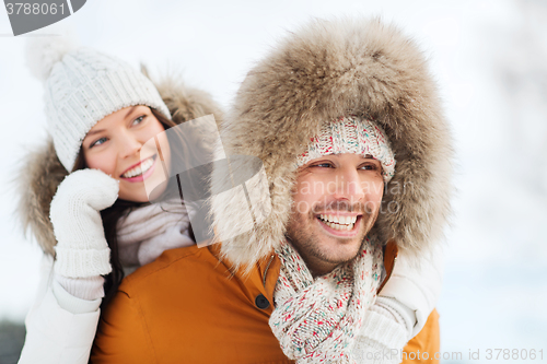 Image of happy couple having fun over winter background