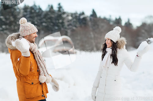 Image of happy couple playing snowballs in winter