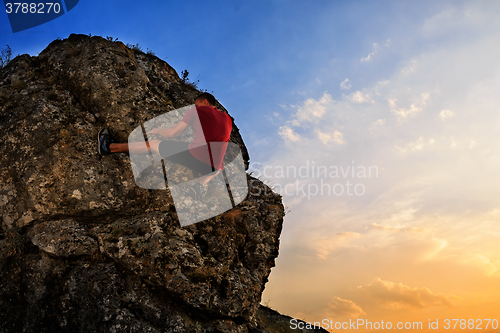 Image of Young man climbing on a wall