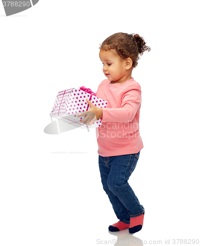 Image of beautiful little baby girl with birthday present