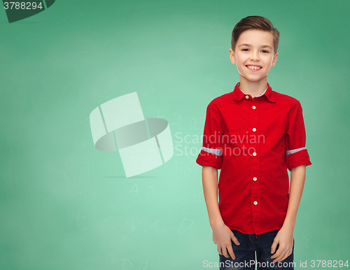 Image of happy boy over green school chalk board