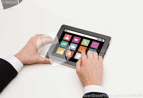 Image of close up of man hands with app icons on tablet pc