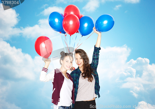 Image of happy teenage girls with helium balloons