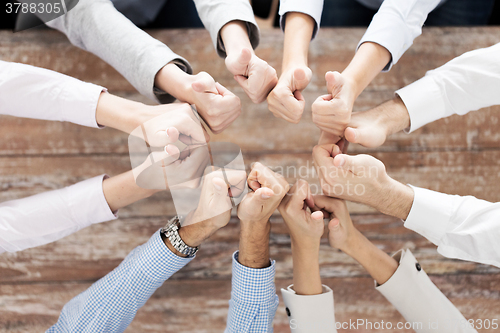 Image of business team showing thumbs up