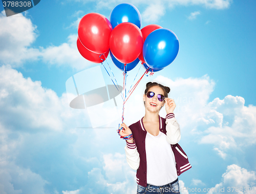 Image of happy teenage girl with helium balloons