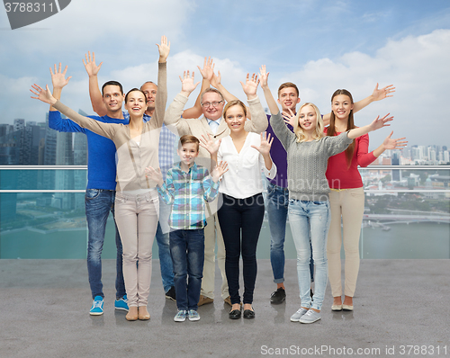 Image of group of smiling people waving hands