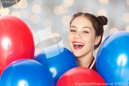 Image of happy teenage girl with helium balloons