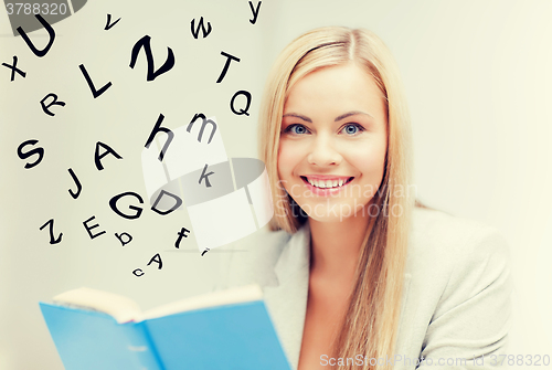 Image of young woman reading book