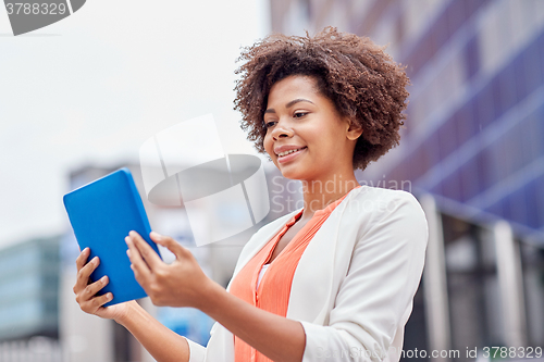 Image of happy african businesswoman with tablet pc in city