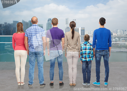 Image of group of people from back over city waterside