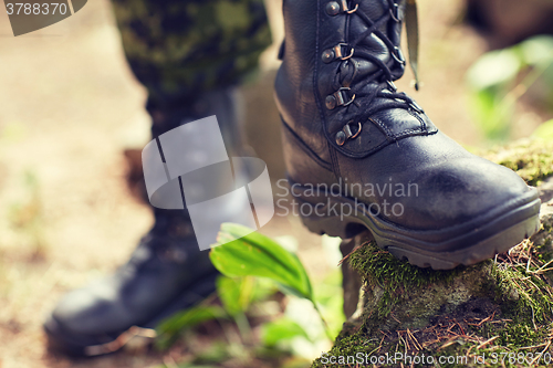 Image of close up of soldier feet with army boots in forest