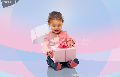 Image of happy little baby girl with birthday present