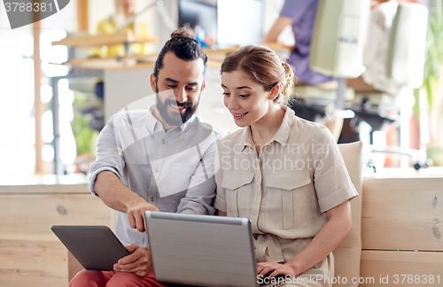 Image of creative team with tablet pc and laptop in office
