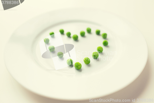 Image of close up of plate with peas in heart shape 