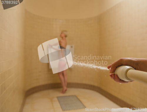 Image of Woman having high pressure massage with Sharko shower