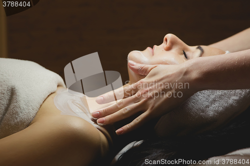 Image of Close-up of young woman with facial mask