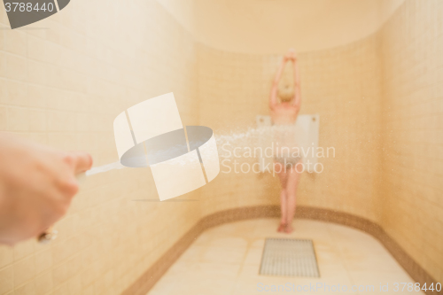 Image of Woman having high pressure massage with Sharko shower