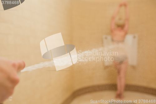 Image of Woman having high pressure massage with Sharko shower
