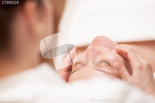 Image of Woman getting professional facial massage