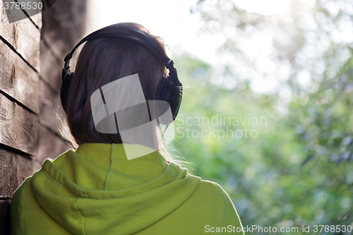 Image of Woman listening to music outdoor